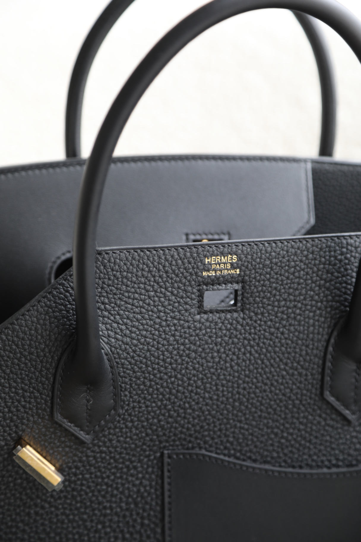 Gold hardware and Hermès stamp on black togo leather